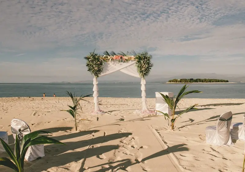 Wedding ceremony arch and seating on a beach